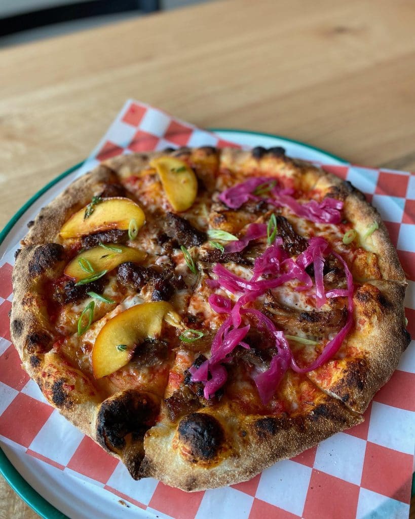 A pizza on a plate Description automatically generated