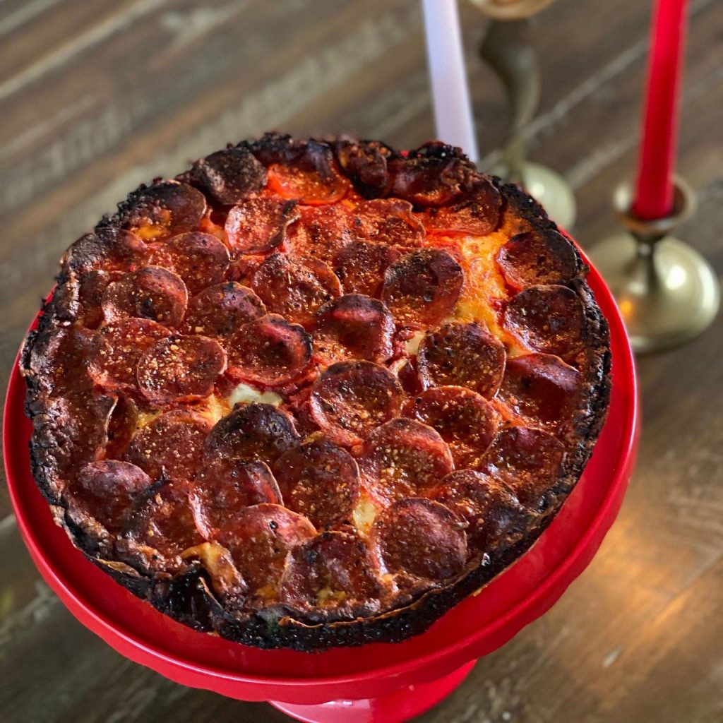 A pizza on a plate

Description automatically generated