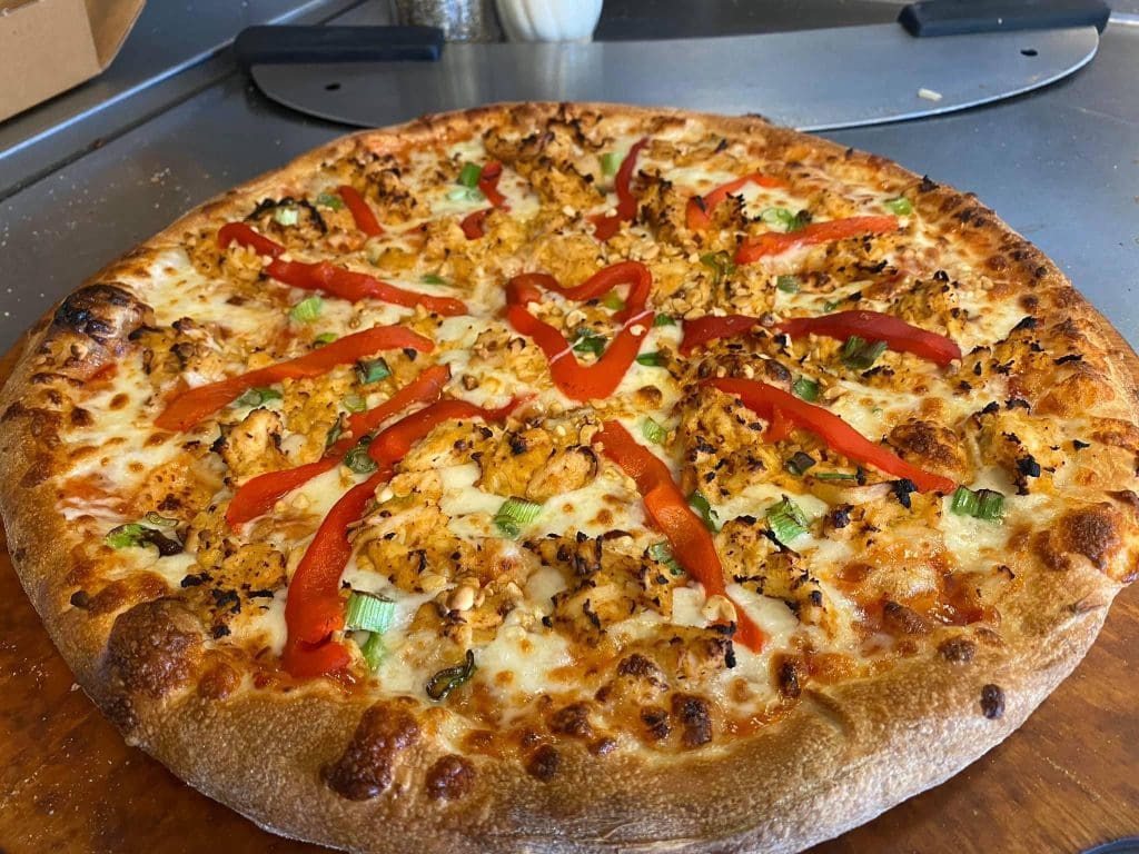 A pizza on a table Description automatically generated