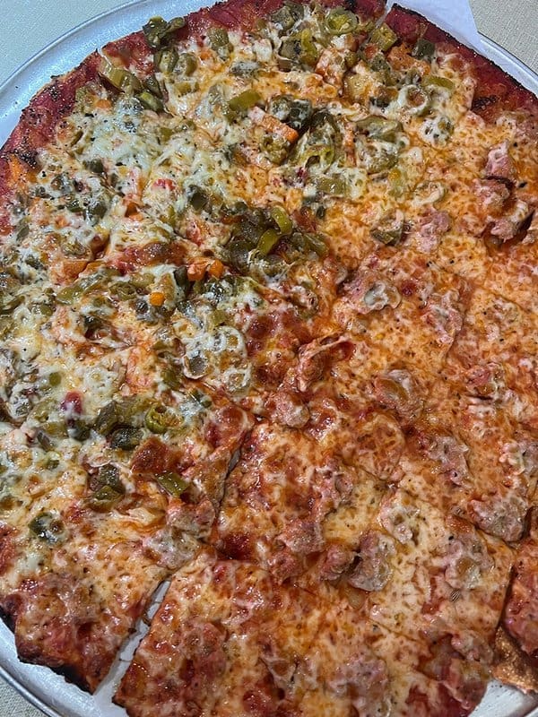 A pizza with jalapenos on it

Description automatically generated