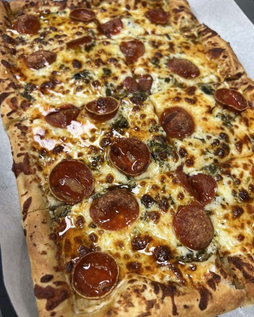 A pizza with pepperoni on top

Description automatically generated