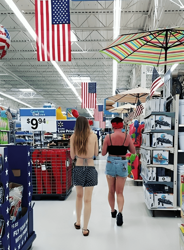 Two women walking in a store Description automatically generated